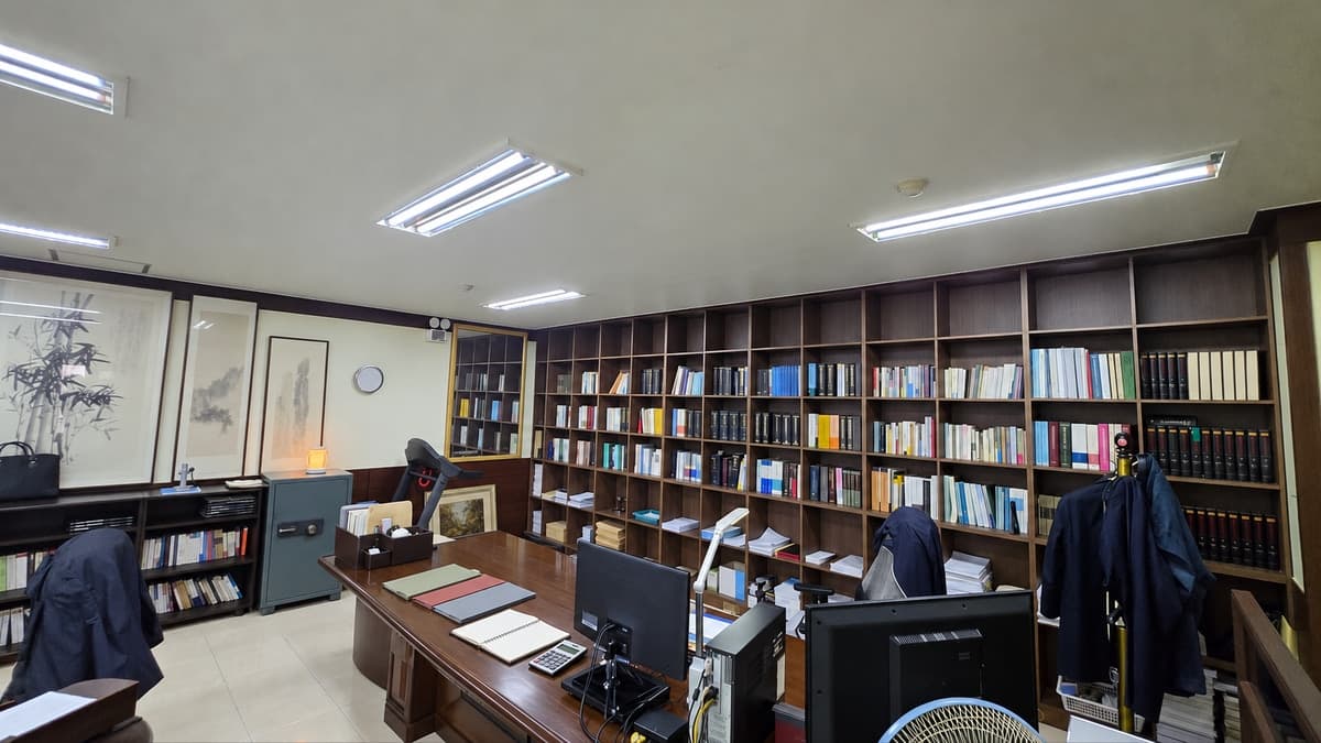 과거 양육비 자료 정리를 표현한 실제 사무실 책상 위 구분 서류철 세 개와 빈 노트, 계산기